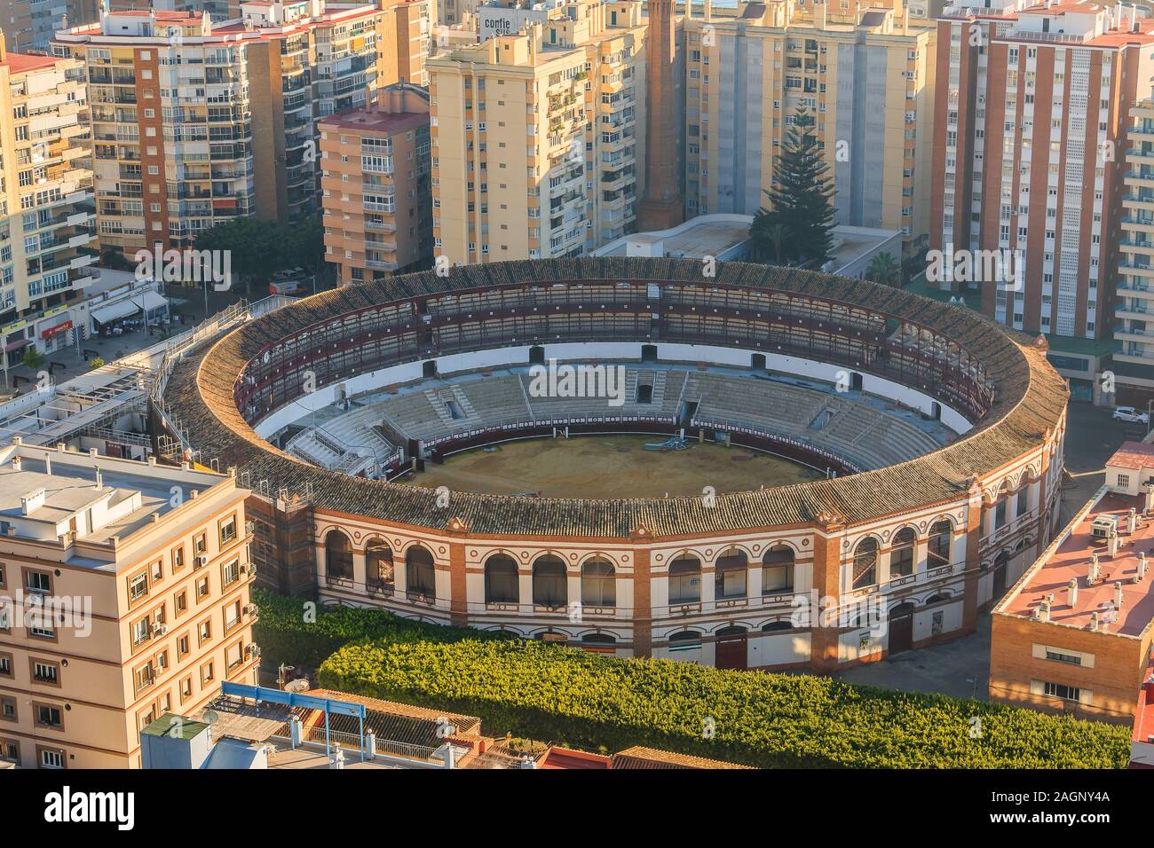 Bullring on the coast of Malaga. In the center of Malaga amid high-rise buildings with a view over the roofs over the city with sunshine Stock Photo