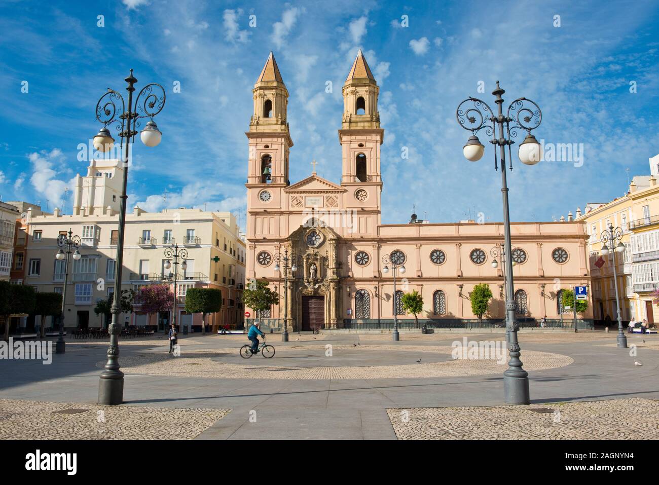 Man riding bicycle in square and Parish church of San Antonio of Padua. Cadiz, Andalusia. Southern Spain Stock Photo