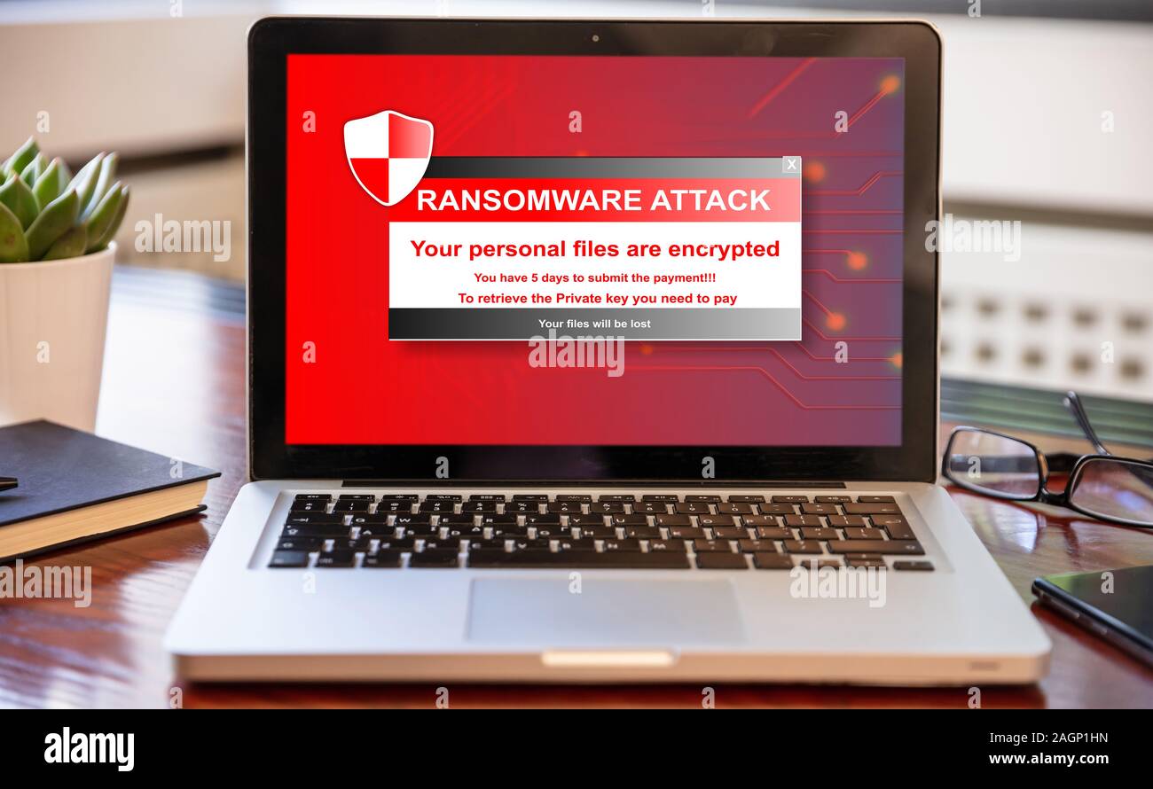 Ransomware text on computer screen, Cyber attack concept. Office business wood desk background. Stock Photo