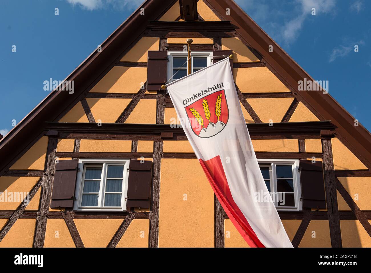 Dinkelsbühl, Germany - July 15, 2019; Old half timbered house with the flag of Dinkelsbühl a populair touristic city in Bavaria Stock Photo