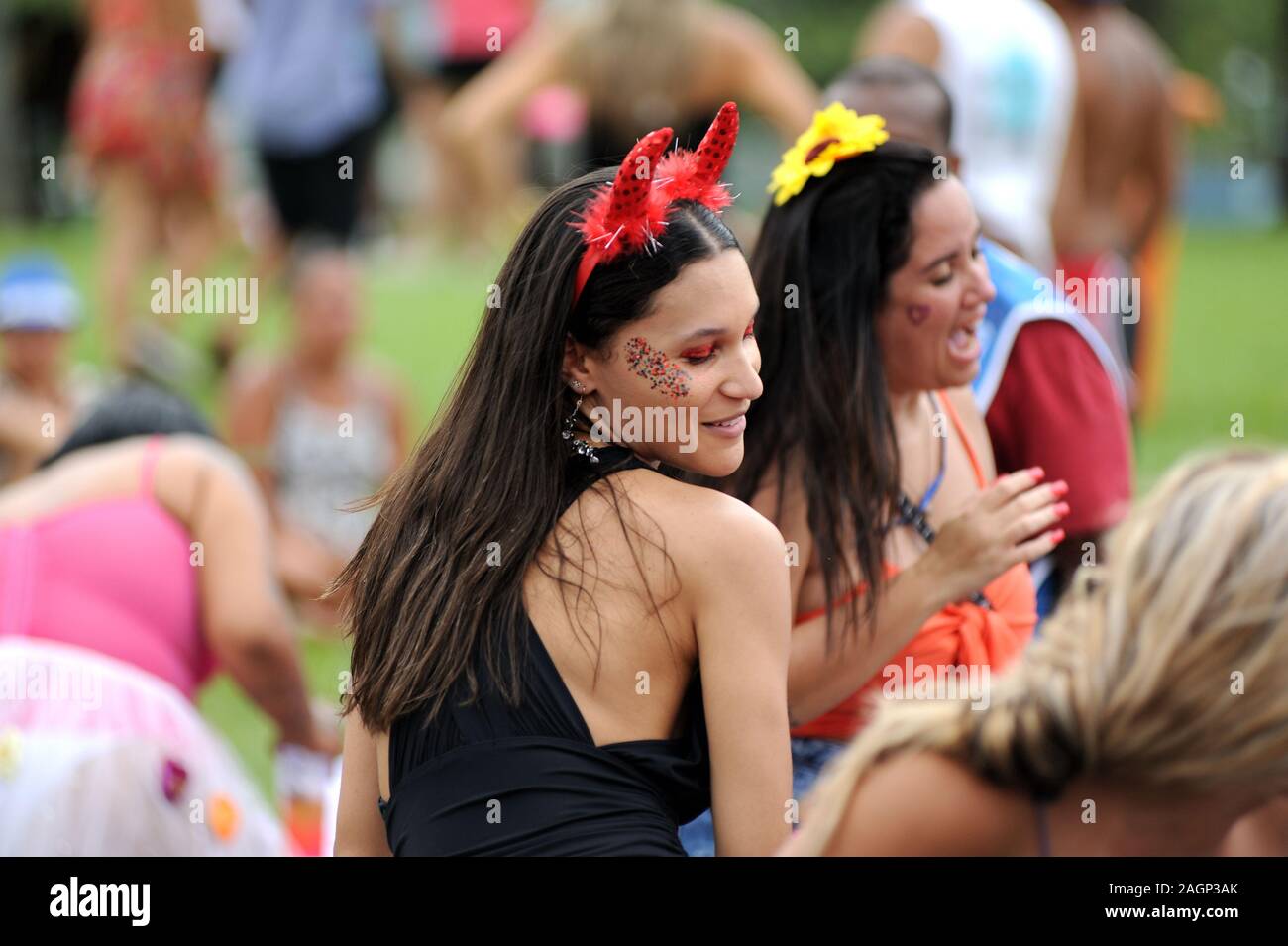 South America, Brazil - March 3, 2019: Disguised reveler enjoys herself during a carnival street parade in Rio de Janeiro. Stock Photo