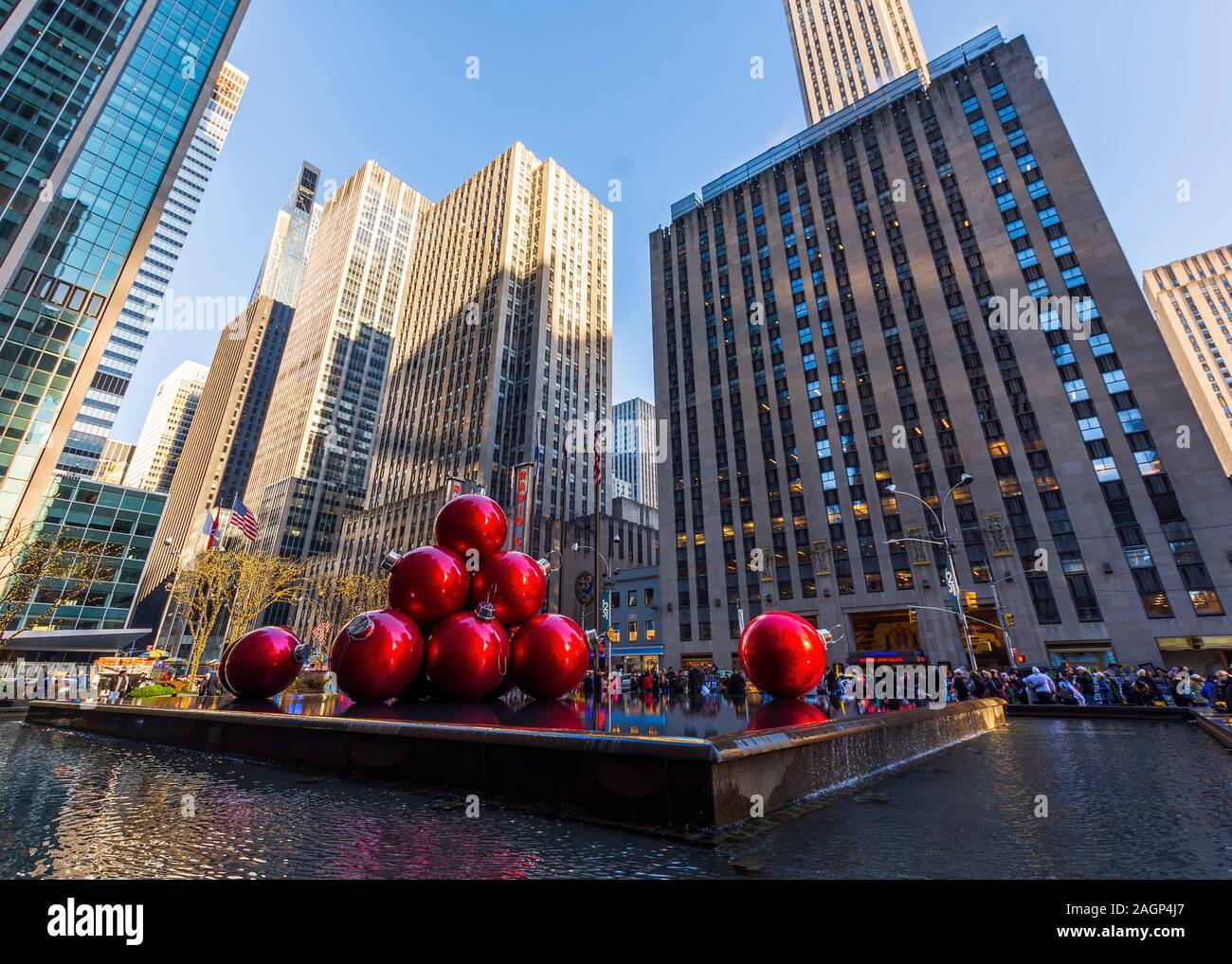New York, NY, USA - November 30, 2019. Streets of Manhattan, Sixth Avenue with huge red Christmas decoration balls, near Radio City Music Hall, NY Stock Photo