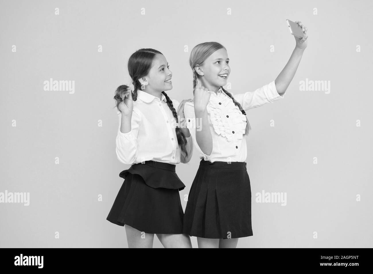 for my profile. kids make selfie photo, friendship. small girls in school uniform. back to school. educational blog. digital technology. online education. knowledge day. happy friends with smartphone. Stock Photo