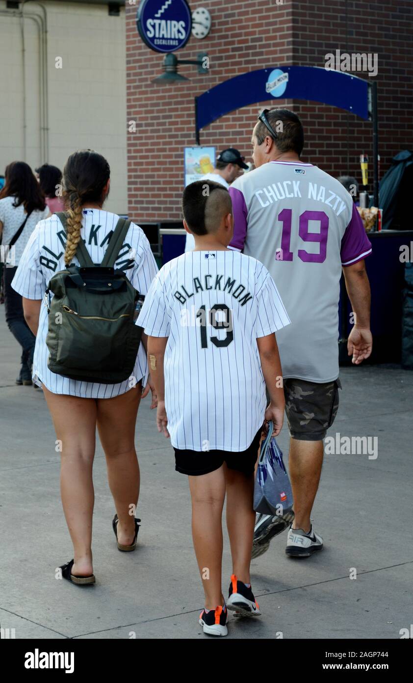 Colorado Rockies baseball fans wearing MLB jerseys showing their