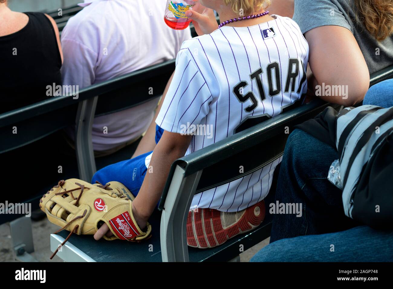 Colorado Rockies baseball fans wearing MLB jerseys showing their favorite Rockies players attend a game at Coors Field in Denver, Colorado. Stock Photo