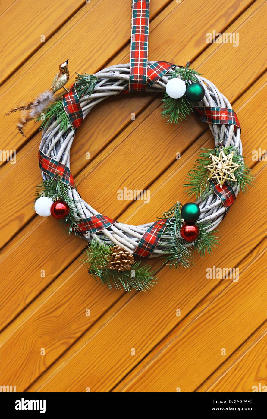 a beautiful retro Christmas wreath hanging on a wooden door Stock Photo