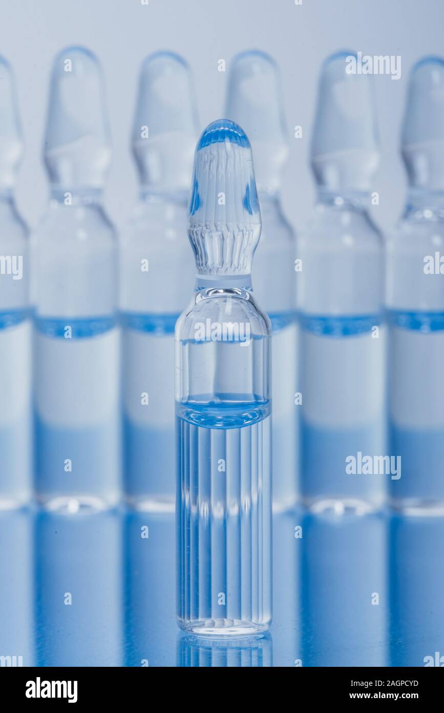 Glass medical ampoule vial for injection. Medicine is liquid sodium chloride with of aqueous