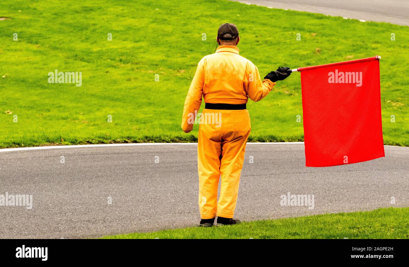Red Flag Racetrack A marshal at a racetrack holds up a red flag to the rider(s Stock Photo ...