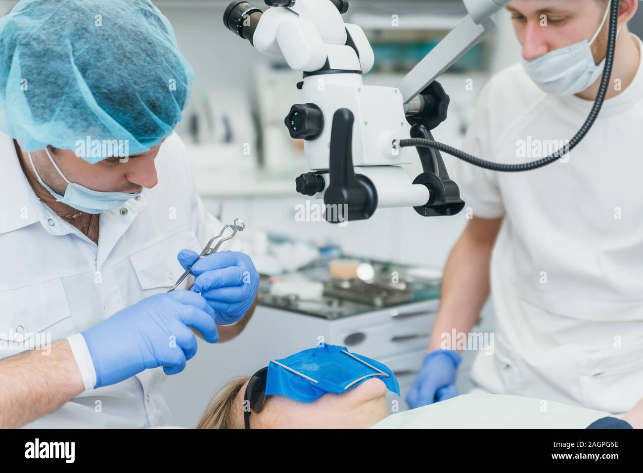 Doctor used microscope. Dentist is treating patient in modern dental