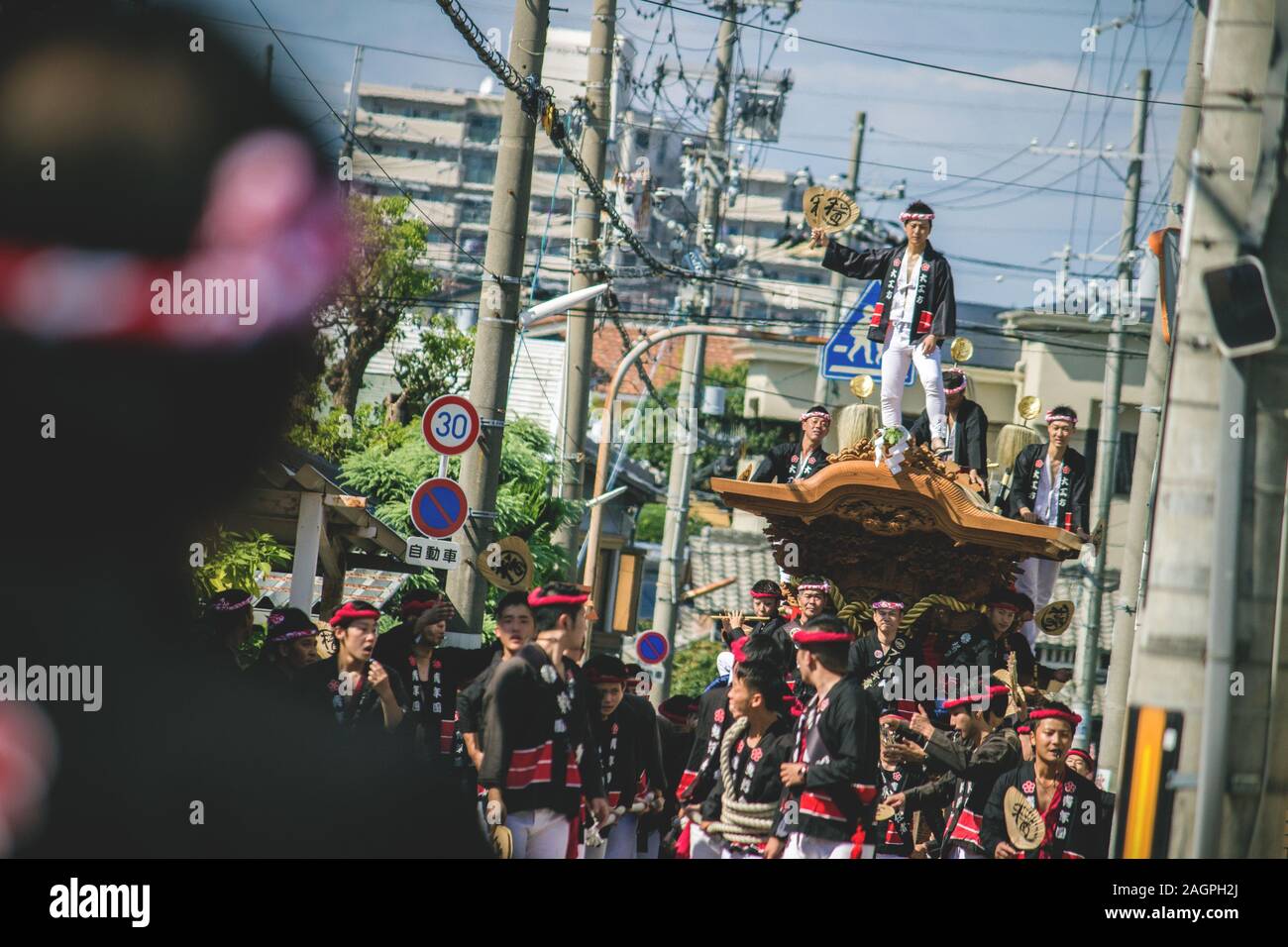 OSAKA, JAPAN - Sep 15, 2015: During the Danjiri-Matsuri religious festival a mikoshi (portable shrine) on wheels is pulled by dozens of men. One man s Stock Photo