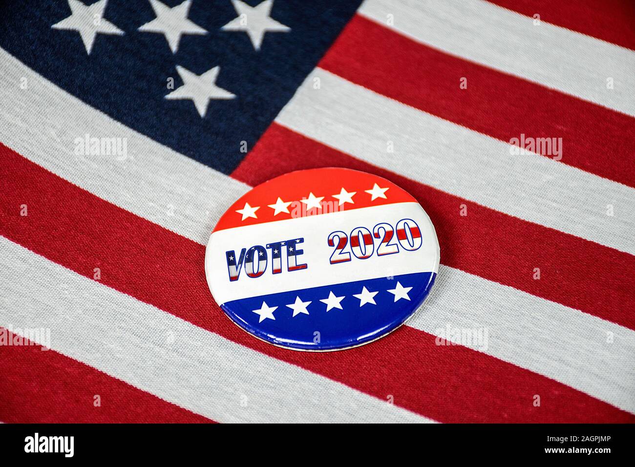 close up of 2020 election campaign pin on American flag Stock Photo