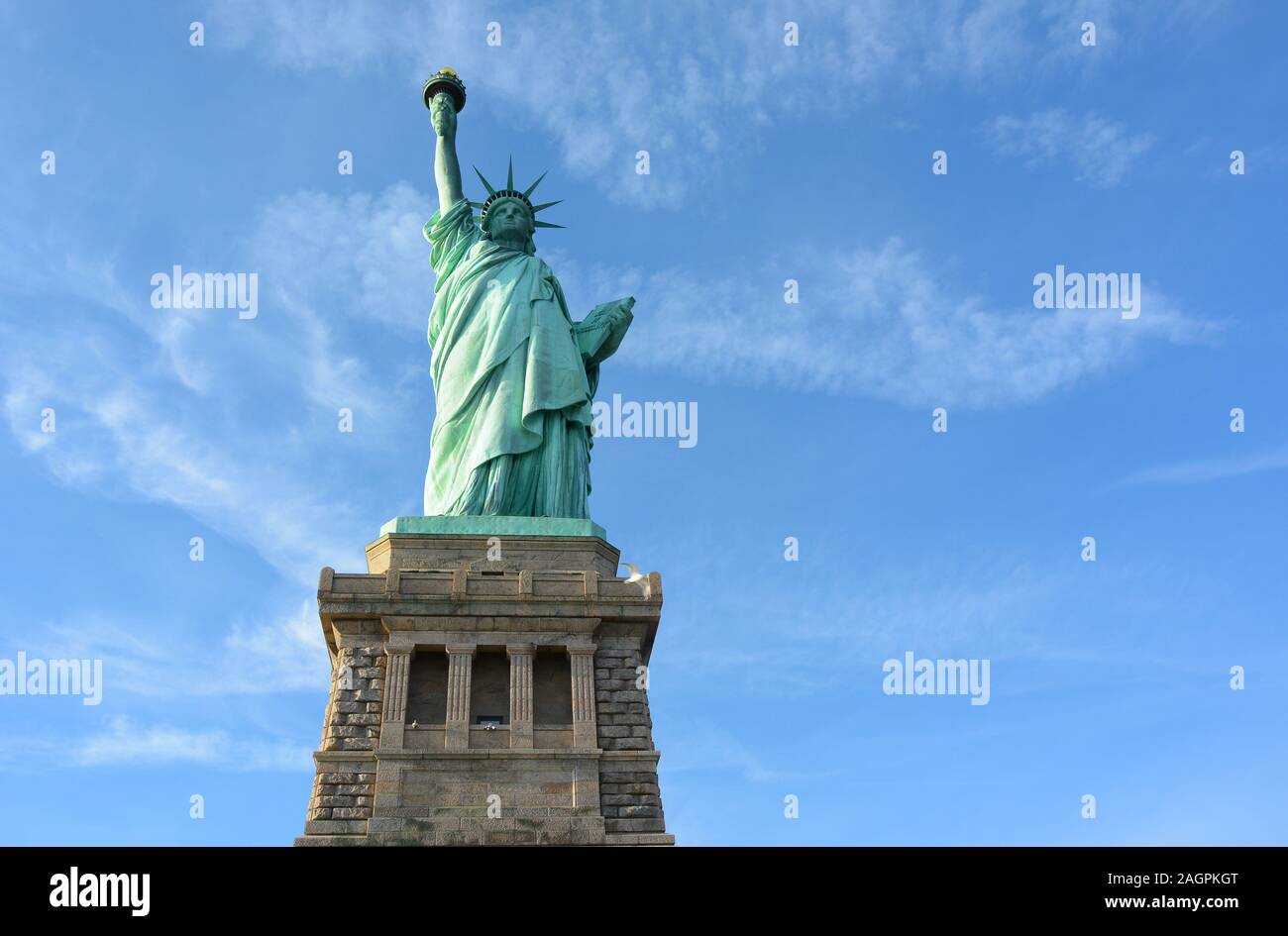 Statue Of Liberty And Pedestal Shot From A Low Angle With Blue