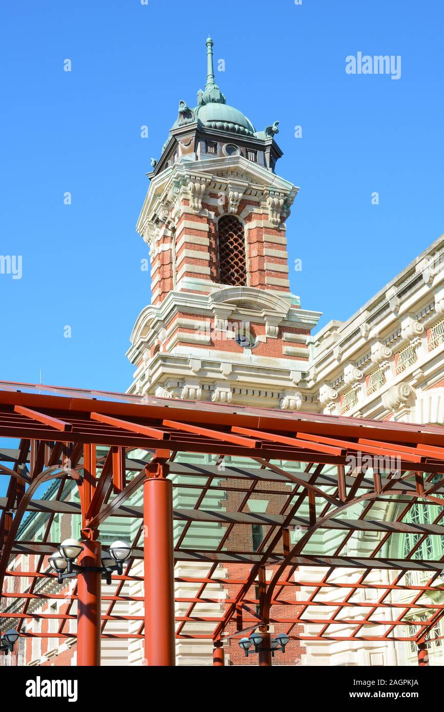 NEW YORK, NY - 04 NOV 2019: Closeup detail  of the Entrance canopy and tower atop the Main Building at Ellis Island National Museum of Immigration. Stock Photo