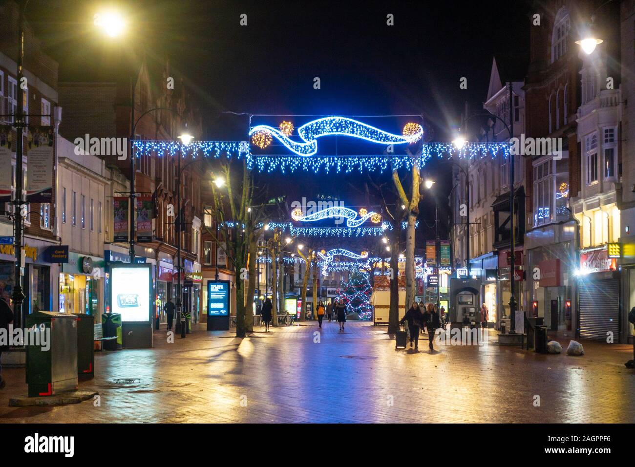Christmas lights hang across Broad Street in Reading, Berkshire at night. Stock Photo