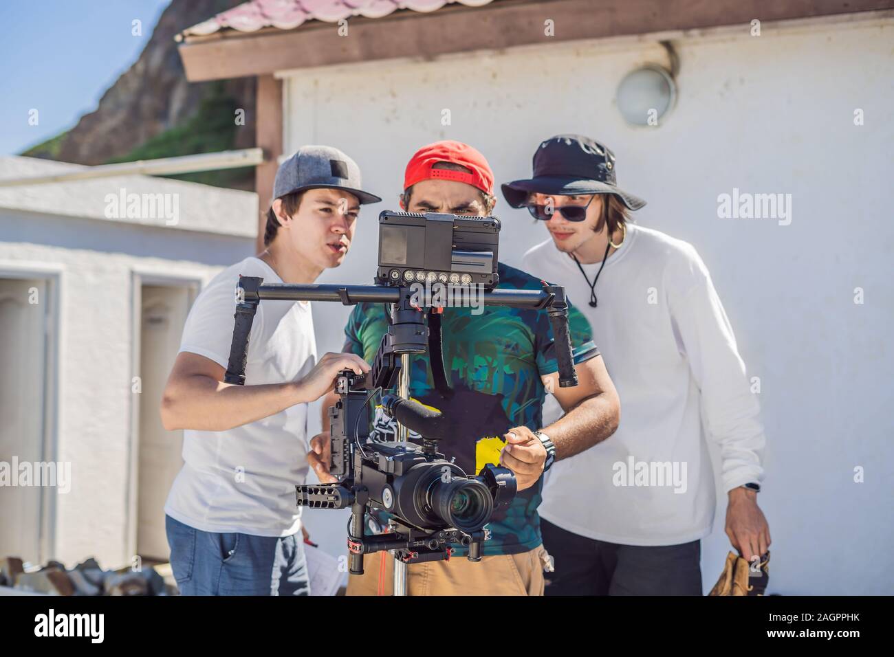 camera operator, director and dp discuss the process of a commercial video  shoot Stock Photo - Alamy