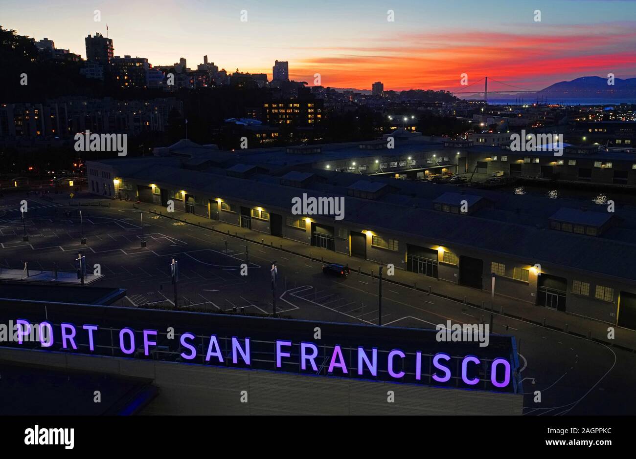 Port of San Francisco sign with Golden Gate Bridge in distance at dusk. Stock Photo