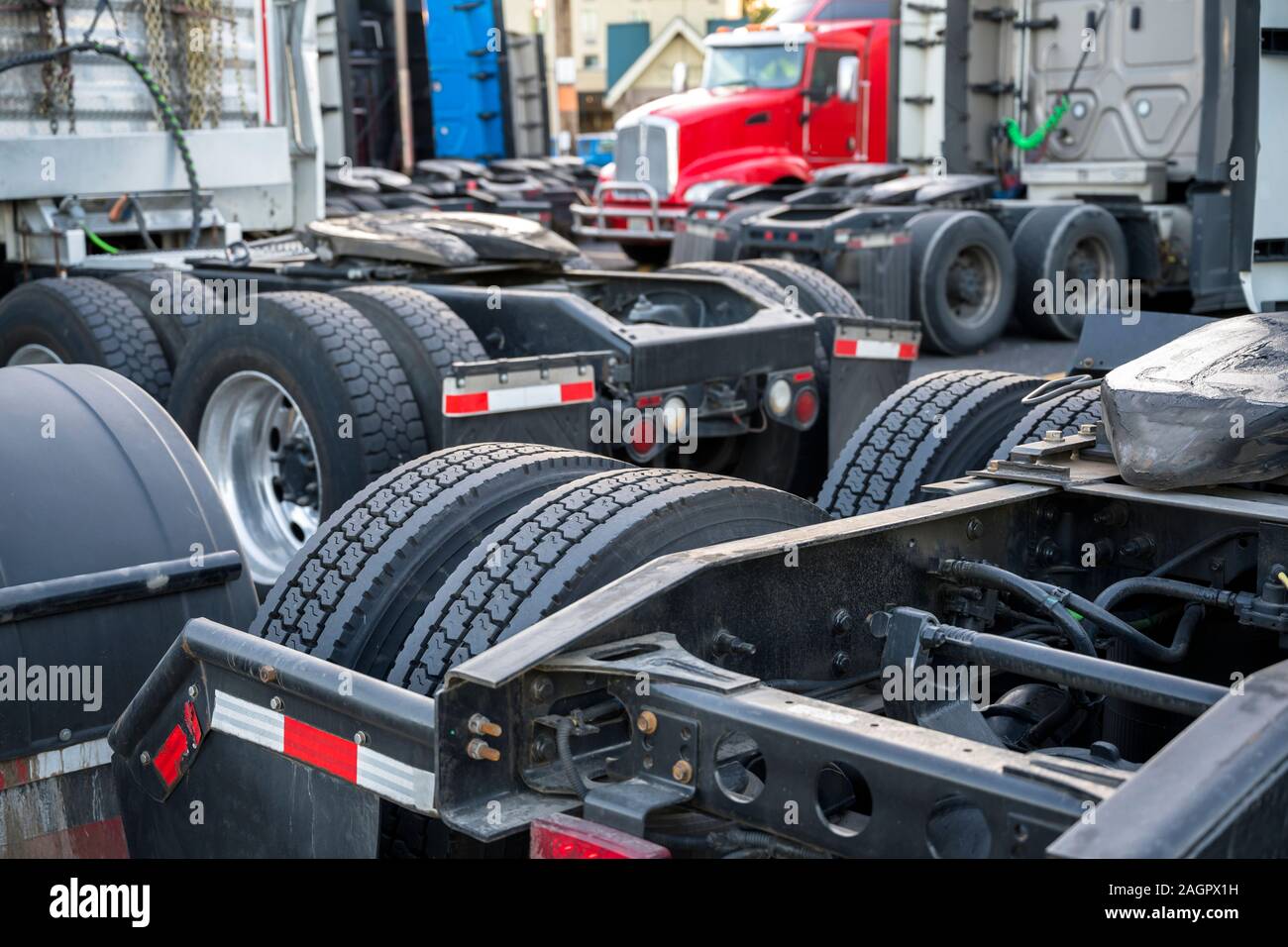 Different Big rigs semi Trucks with frames with rear dual drive wheels