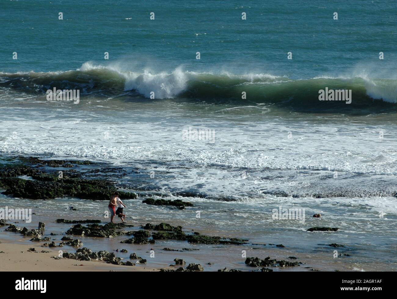 Children playing in the rock pools at Halls Head beach, Mandurah, Western Australia Stock Photo