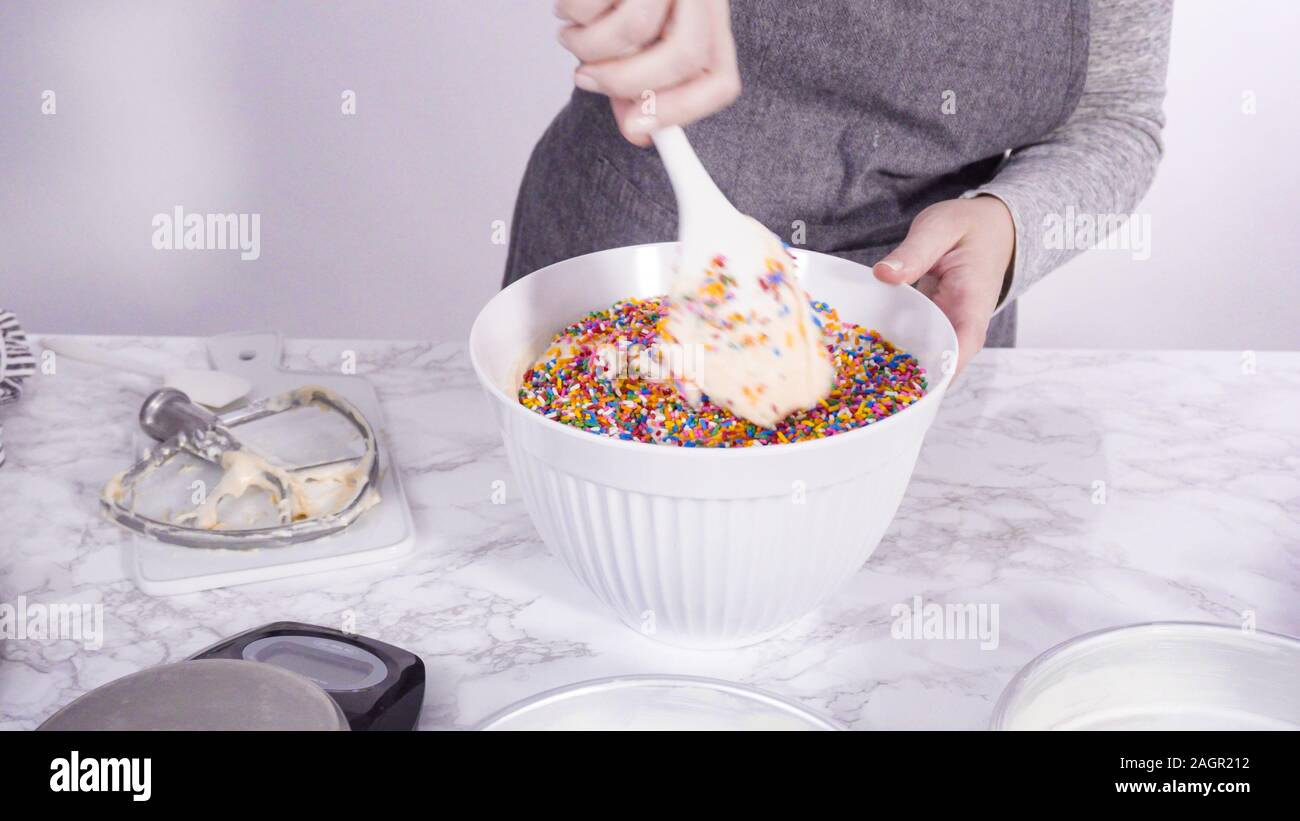 Step by step. Mixing in colorful sprinkles into the cake batter to make