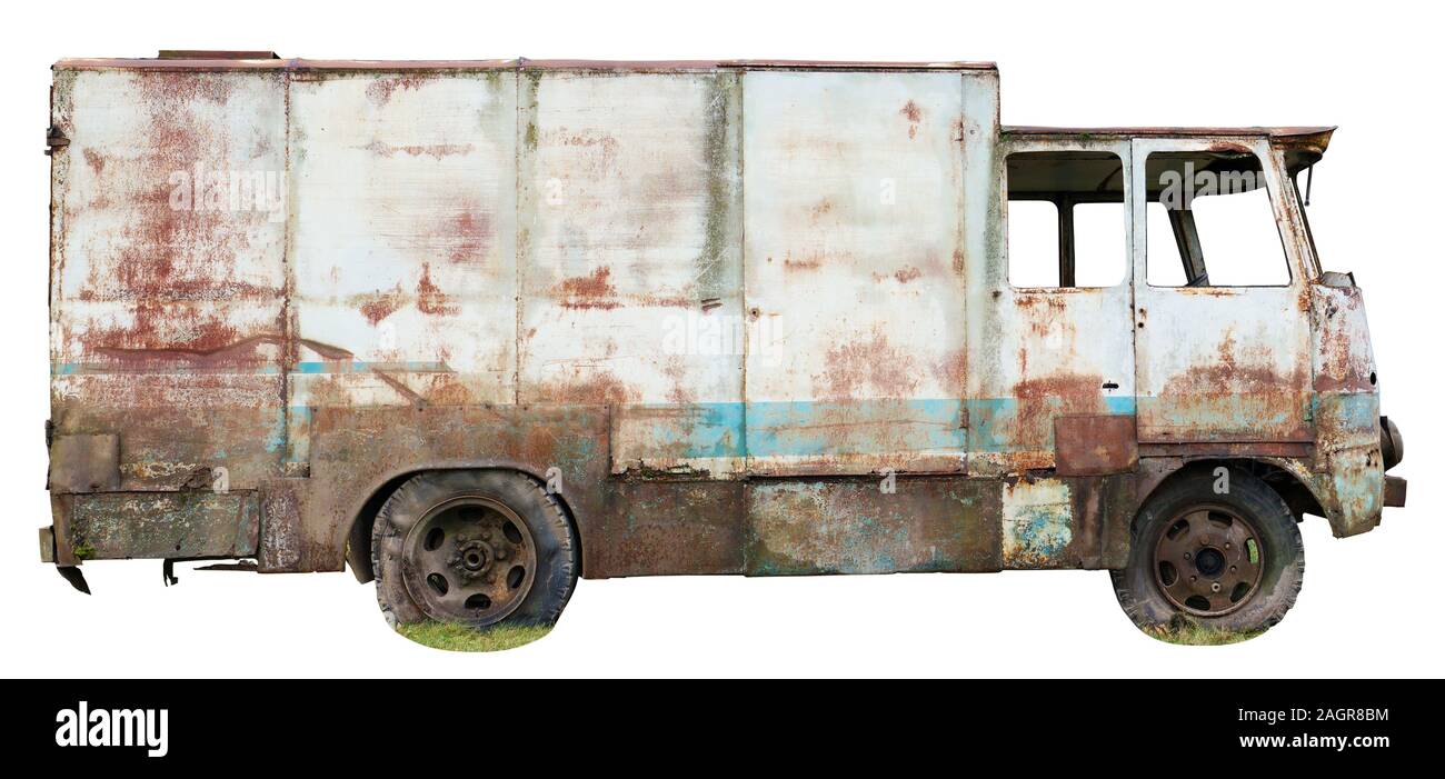 Decayed rusty nameless car van for transportation of agricultural products and bread thrown in the forest. Isolated on white right  side view Stock Photo