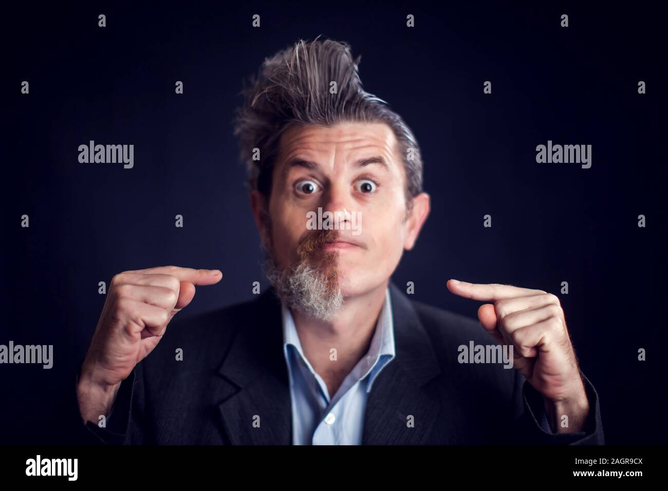 Half bearded funny man wearing suit in front of black background. People and skin care concept Stock Photo