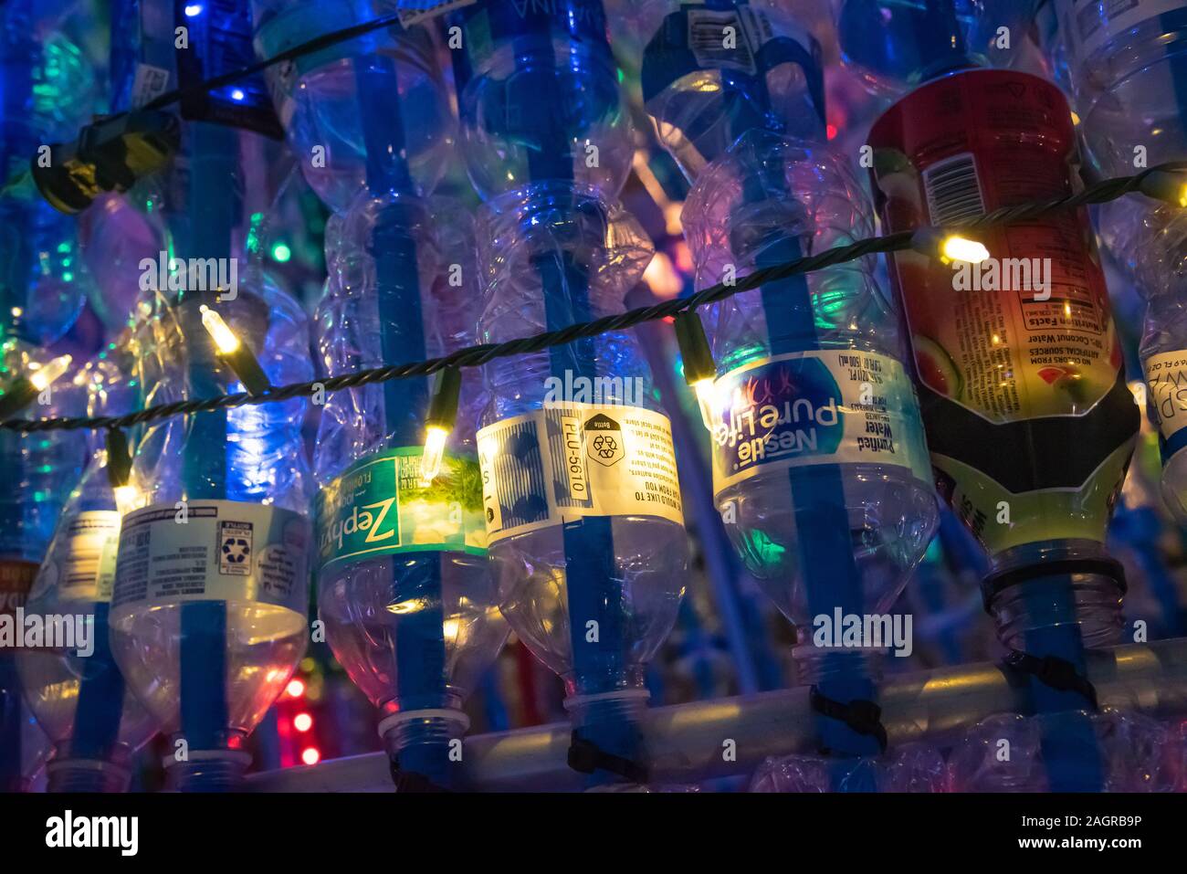 Lighted plastic bottles used in a large-scale recycled sculpture for Jacksonville Beach's holiday season public art event, Deck the Chairs. Stock Photo