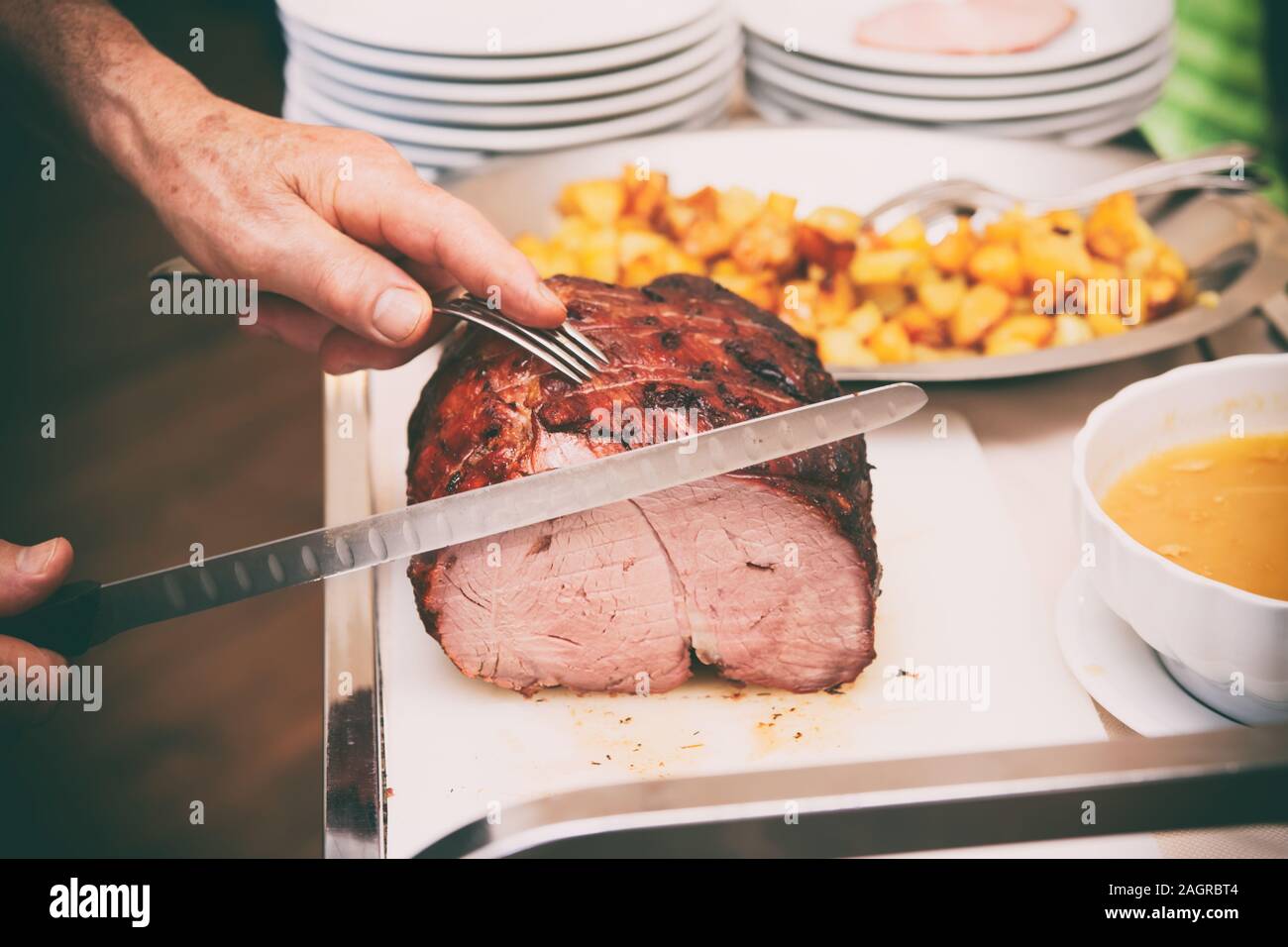 https://c8.alamy.com/comp/2AGRBT4/chef-is-cutting-beefsteak-with-carving-knife-toned-image-2AGRBT4.jpg