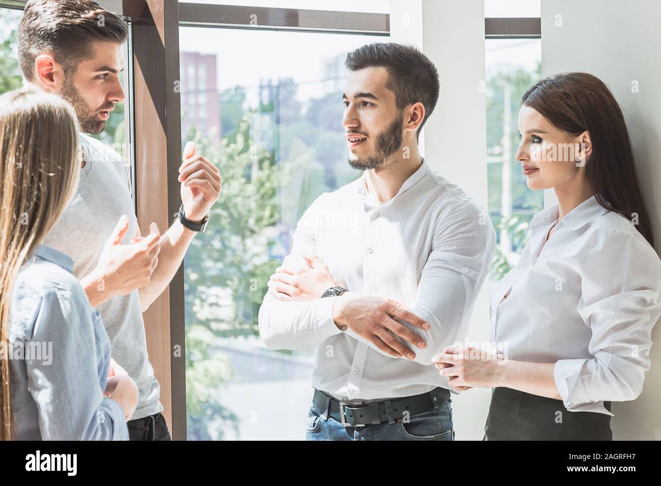 Young students discuss the topic of a lecture in between classes Stock Photo