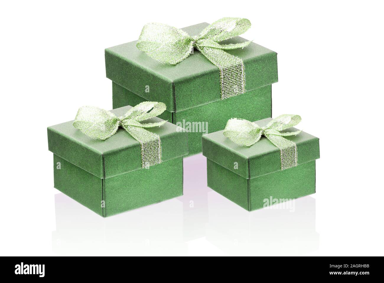 Three green gift boxes isolate on a white background, close-up, reflection. Stock Photo
