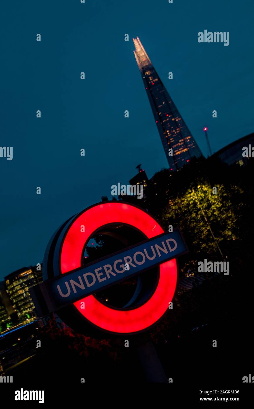 August 17, 2019 – Tower Hill, London, United Kingdom. A bright Underground sign at night. The London Underground is the fastest method to travel aroun Stock Photo