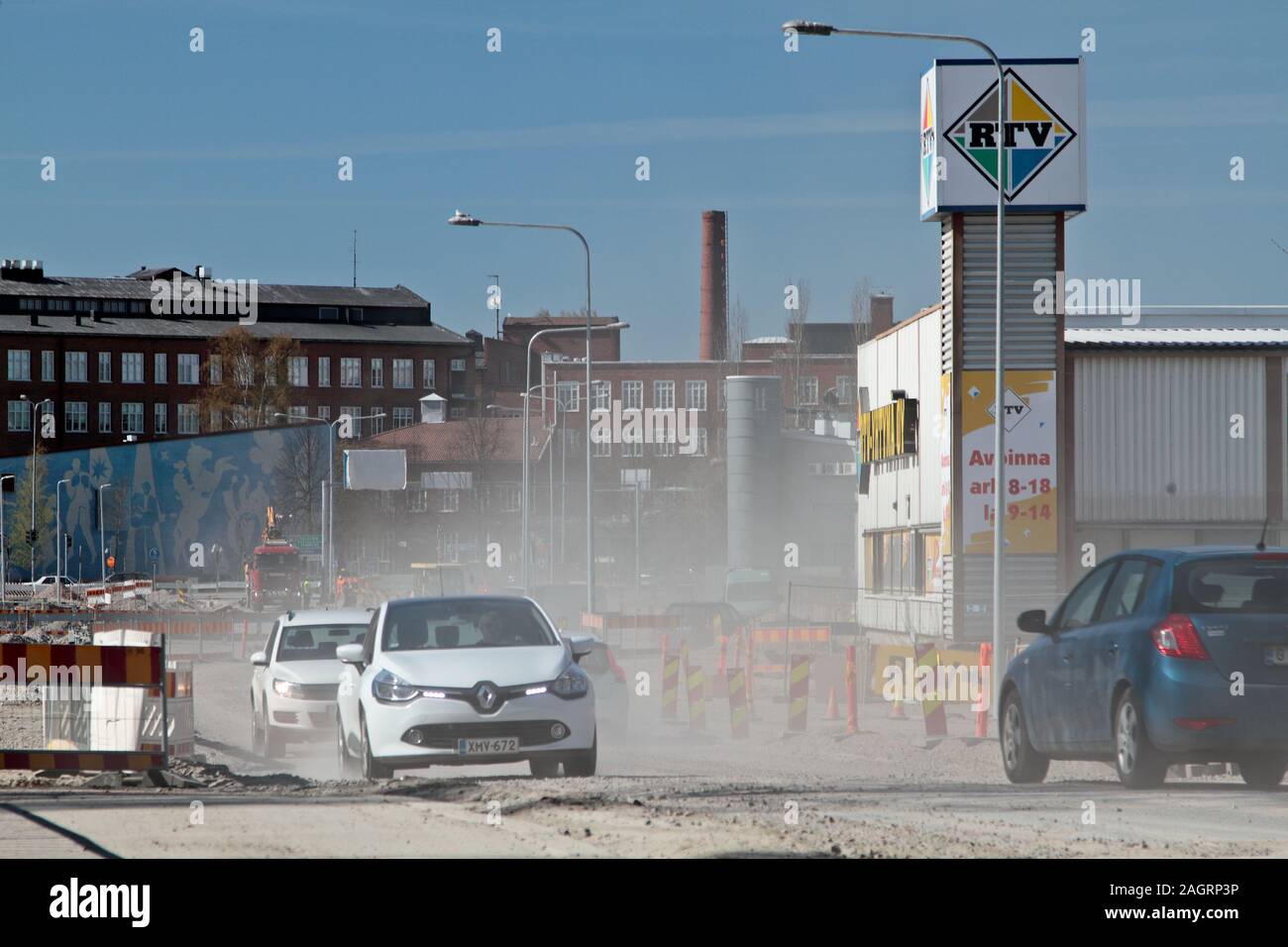 Hämeenlinna Finland 05/03/2016 Roadworks in the city. Passing cars lift dust into the air from a sandy base Stock Photo