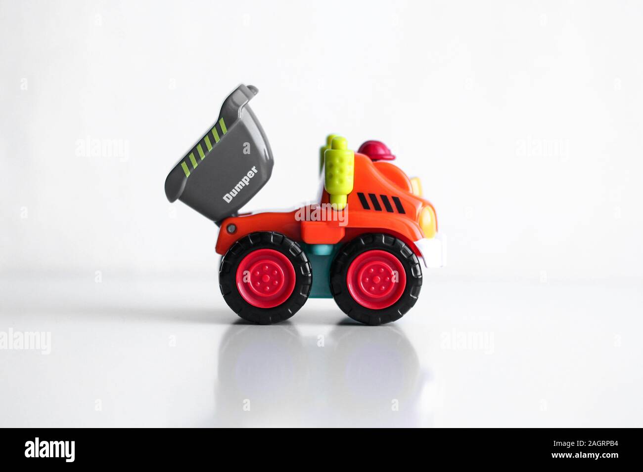Plastic dump truck toy construction vehicle isolated on white