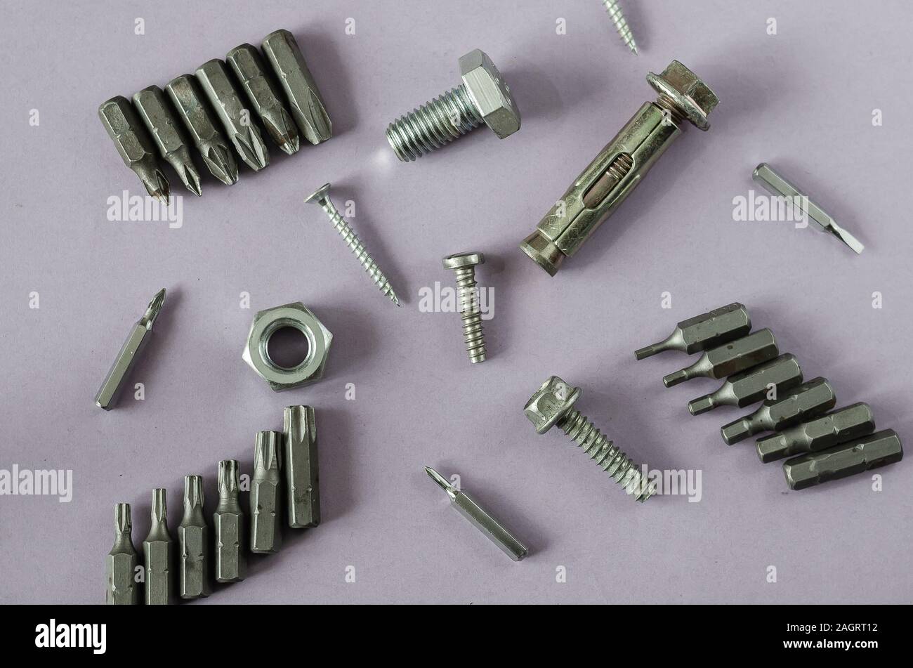 Used bit sets for screwdriver. Bolts, nuts, screws and anchor bolt on a