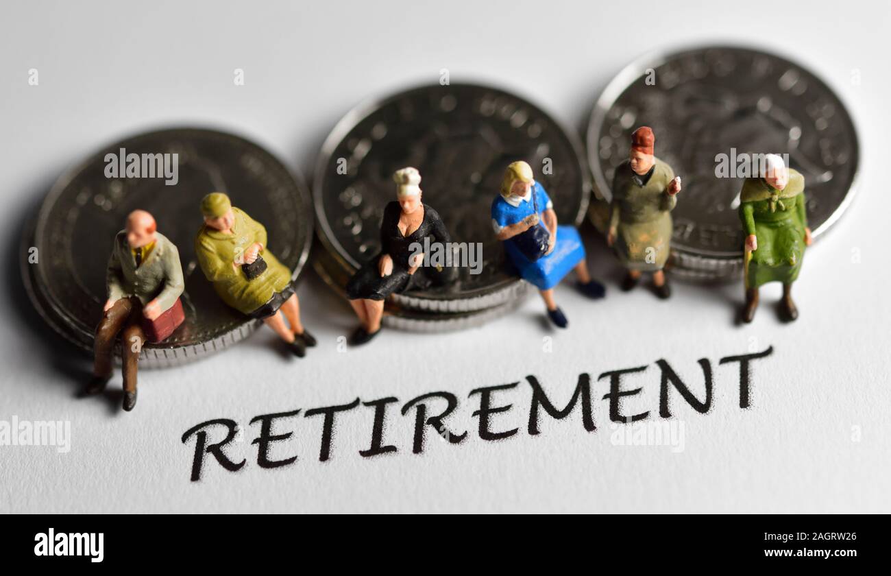 People sitting on coins behind the word retirement Stock Photo