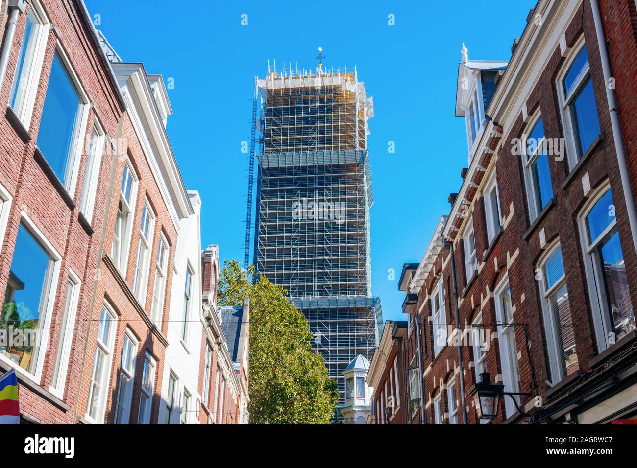 Dom Tower of the St. Martins Cathedral on a sunny day viewed from the Zadelstraat (Saddle Street), completely surrounded by scaffolding due to renovat Stock Photo