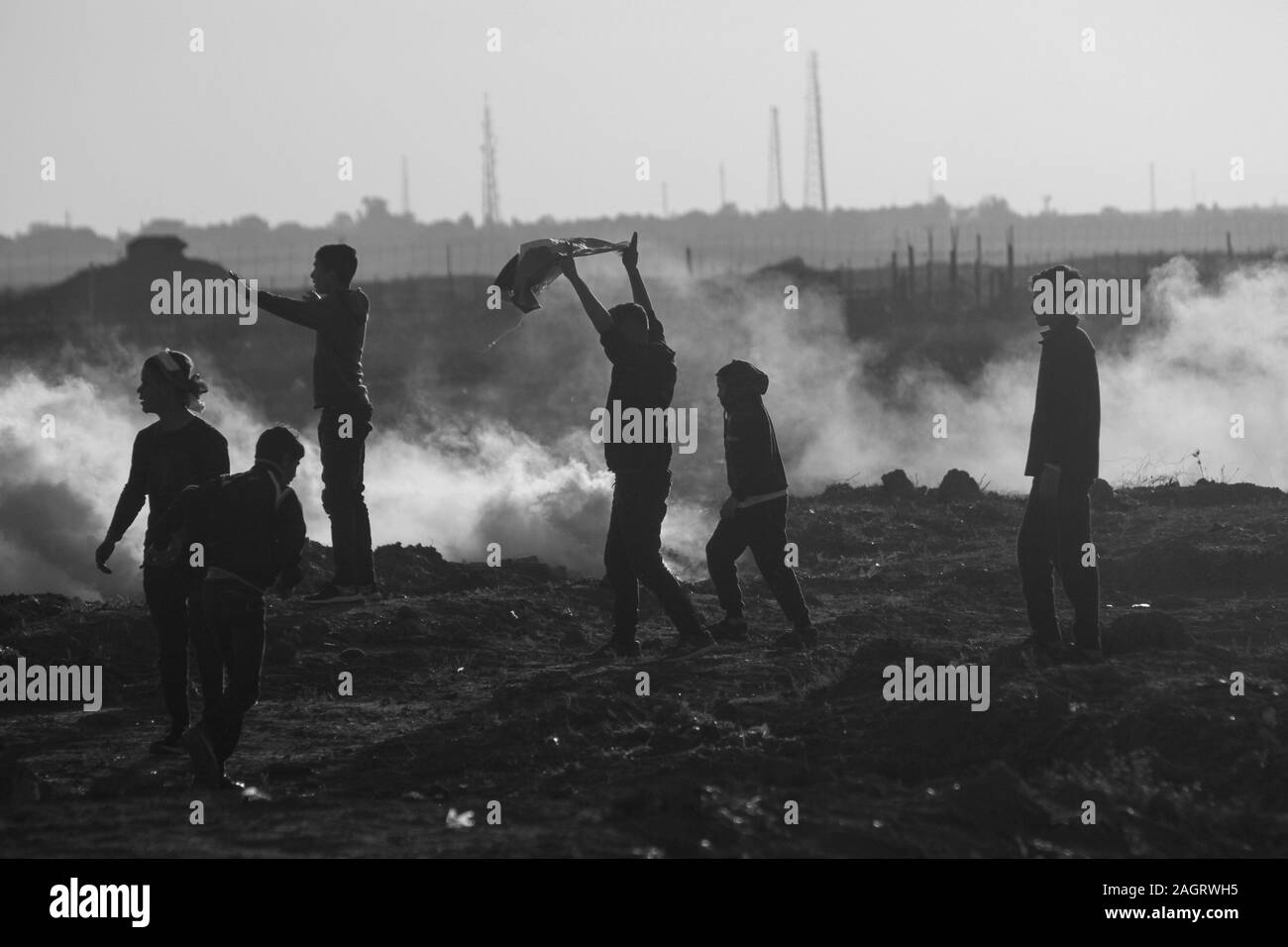 December 20, 2019: Gaza, Palestine. 20 December 2019. Palestinian youths clash with Israeli soldiers in Abu Safiya, in the northern Gaza Strip, during this Friday's border protests. Hundreds of protesters had gathered on Friday afternoon at different sites closed to the Gaza-Israeli border, as part of the Great March of Return rallies. Dozens of Palestinian demonstrators were injured on Friday by Israeli soldiers' tear gas and gunfire. Since March 30 last year, demonstrators in Gaza have been calling for an end to Israel's 12-year-long blockade on the Gaza Strip. The blockade has cripple Stock Photo