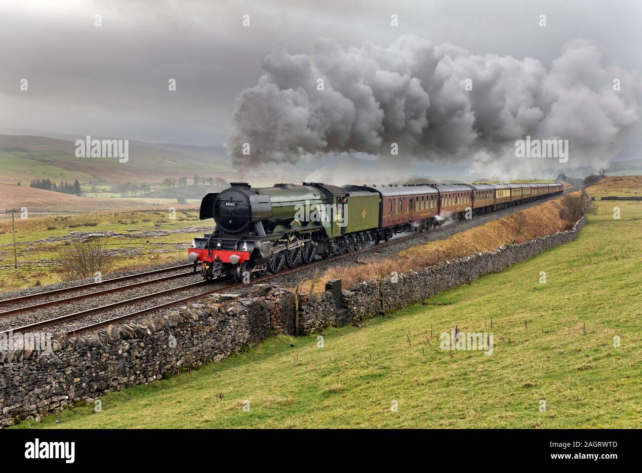 Ribblesdale, North Yorkshire, UK. 21st Dec, 2019. On a wet and murky Winter's day, The Flying Scotsman locomotive is seen with 'The Christmas Dalesman' steam special. Seen here at Selside near Horton-in-Ribblesdale in the Yorkshire Dales National Park, travelling north to Carlisle on the famous Settle to Carlisle railway line, on a round trip from Manchester. The return trip was via Shap on the West Coast main line. Credit: John Bentley/Alamy Live News Stock Photo