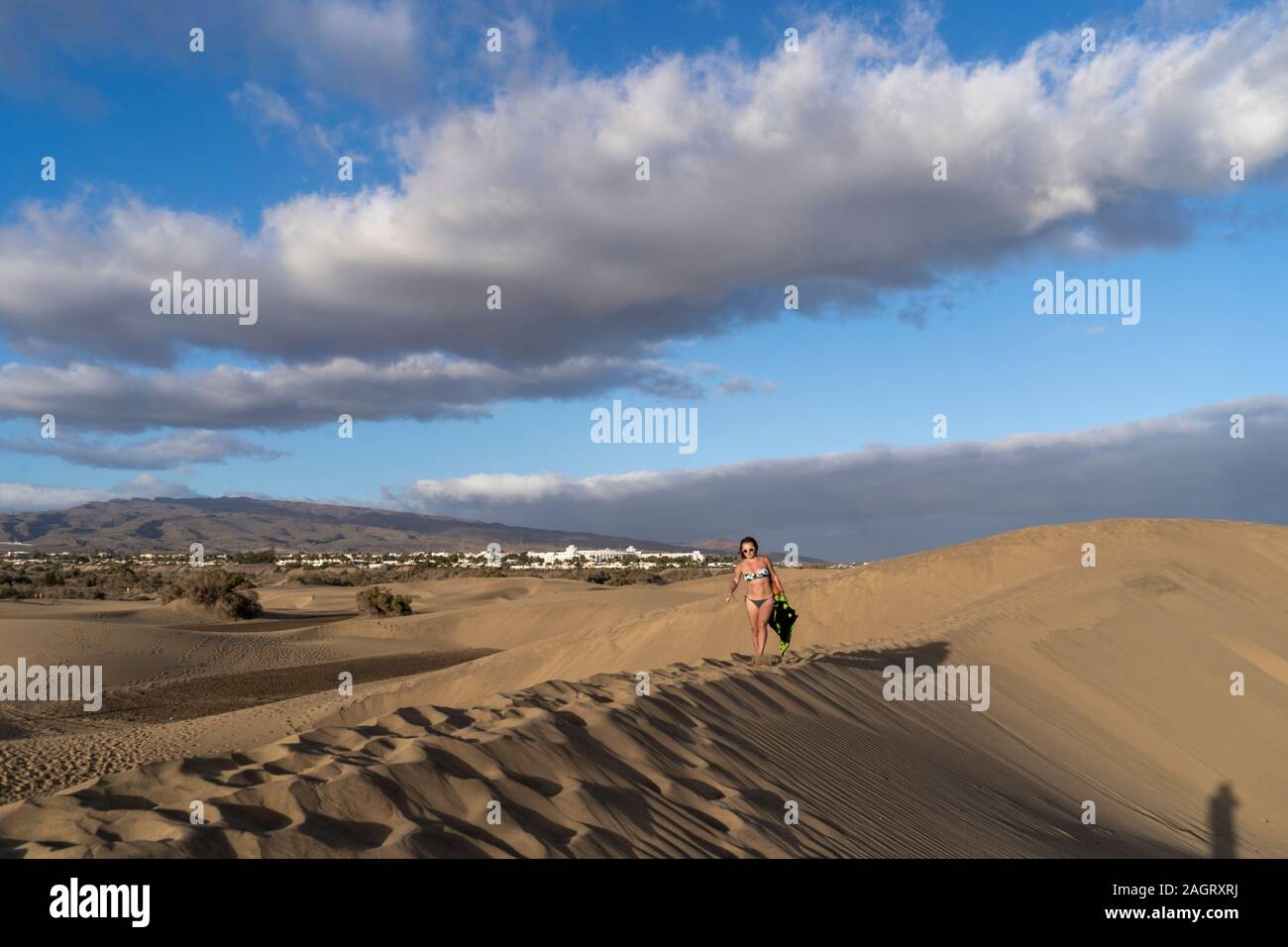 Tourists enjoying the sun bathing on the dunes of Maspalomas, in Gran Canaria, Spain Stock Photo
