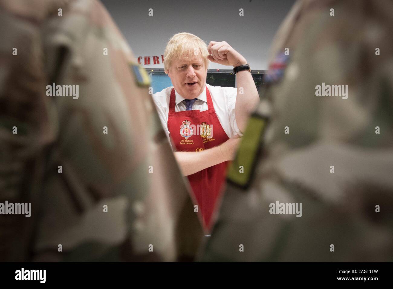 Prime Minister Boris Johnson serves Christmas lunch to British troops stationed in Estonia during a one-day visit to the Baltic country. PA Photo. Picture date: Saturday December 21, 2019. The Prime Minister thanked the servicemen and women for their work as he joined them for lunch at the Tapa military base near the capital Tallinn. The base is home to 850 British troops from the Queen's Royal Hussars who lead the Nato battlegroup along with personnel from Estonia, France and Denmark. See PA story POLITICS Estonia. Photo credit should read: Stefan Rousseau/PA Wire Stock Photo