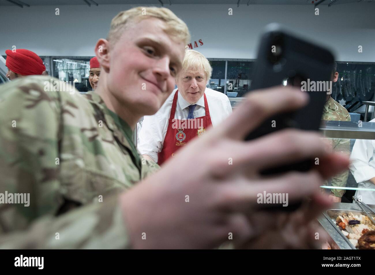 Prime Minister Boris Johnson meets soldiers after serving Christmas lunch to British troops stationed in Estonia during a one-day visit to the Baltic country. PA Photo. Picture date: Saturday December 21, 2019. The Prime Minister thanked the servicemen and women for their work as he joined them for lunch at the Tapa military base near the capital Tallinn. The base is home to 850 British troops from the Queen's Royal Hussars who lead the Nato battlegroup along with personnel from Estonia, France and Denmark. See PA story POLITICS Estonia. Photo credit should read: Stefan Rousseau/PA Wire Stock Photo