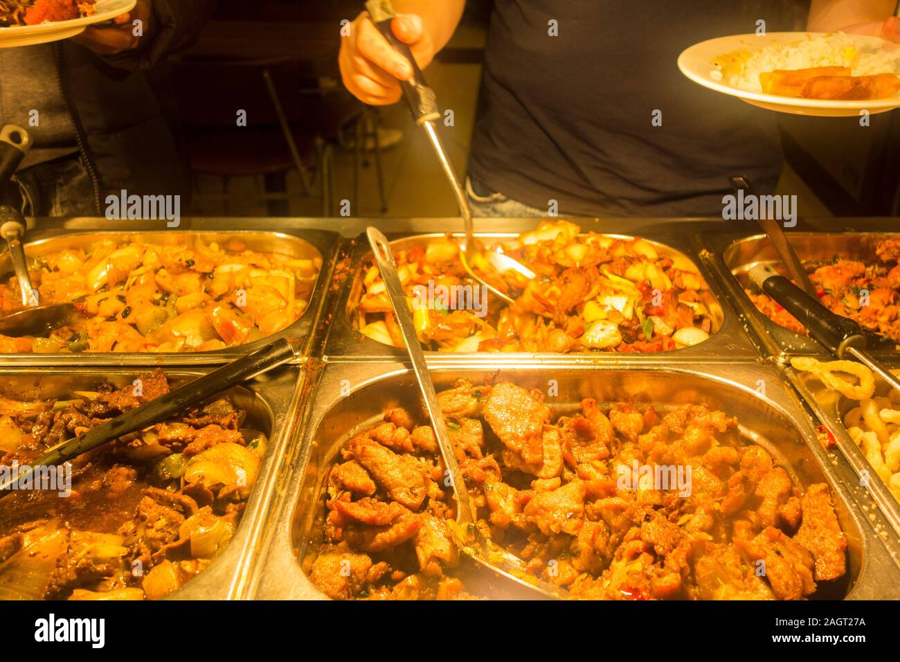 Customers serving themselves in a Chinese buffet restaurant in Chinatown, Soho, London, UK Stock Photo