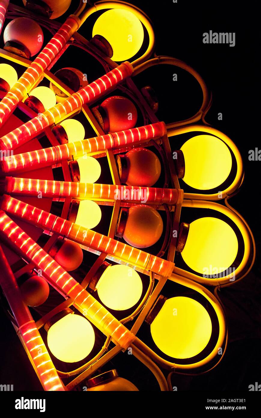 Detail of a decorative lamp post with round yellow lights against a