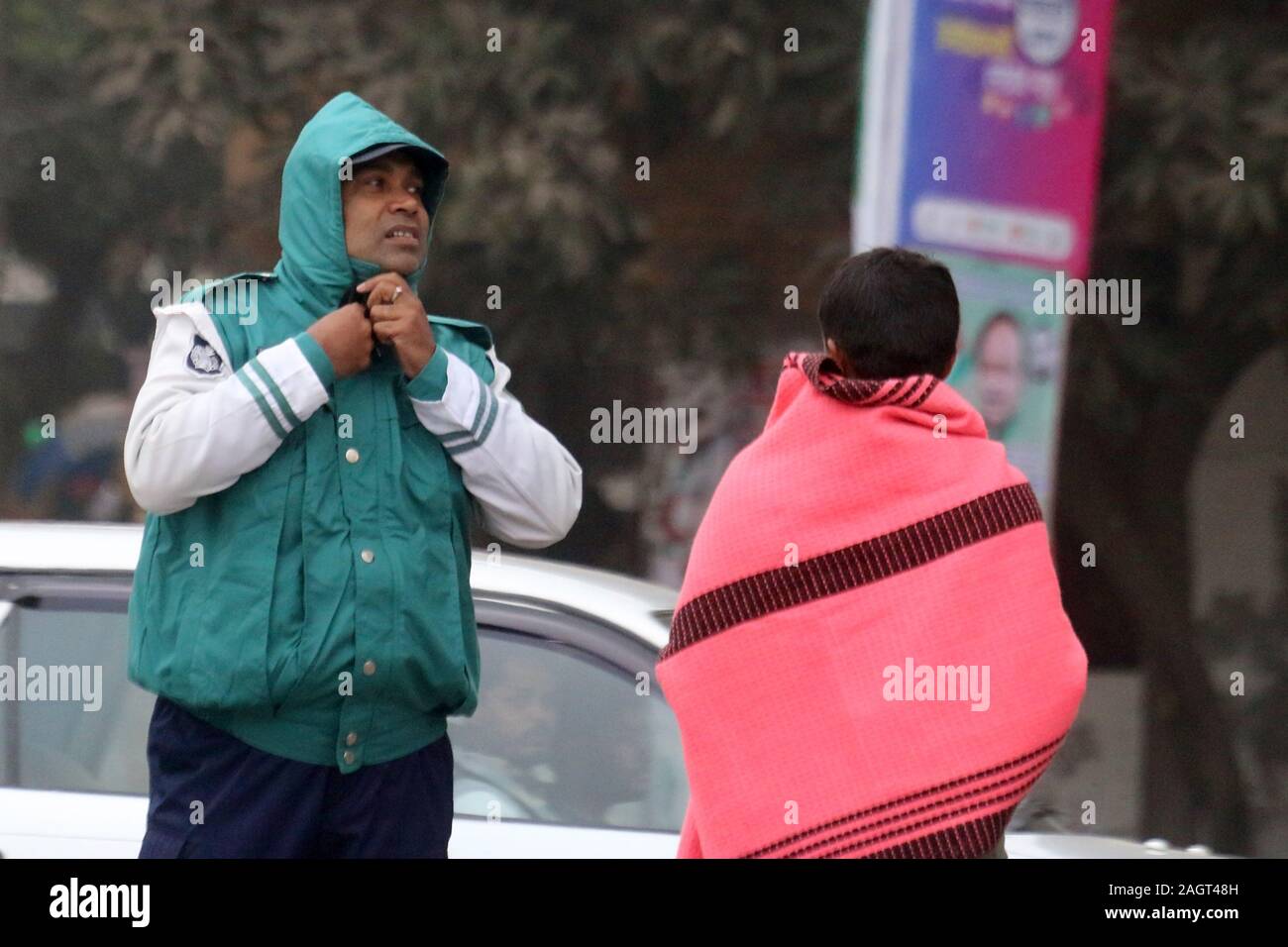 Dhaka, Bangladesh. 22nd Dec, 2019. A traffic Police officer wears a jacket during a cold wave in Dhaka.A biting cold spell continues to sweep across northern Bangladesh and a few other parts of the country although mercury readings point to an end to a cold wave. Credit: Sultan Mahmud Mukut/SOPA Images/ZUMA Wire/Alamy Live News Stock Photo