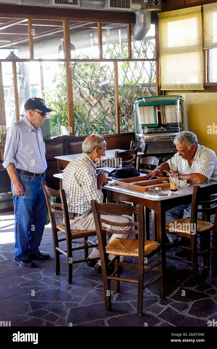 Interior showing Elders playing Tavli at Kafeneio Ermis. The Oldest in Mytilini, Lesbos, Greece And the JukeBox works. Stock Photo