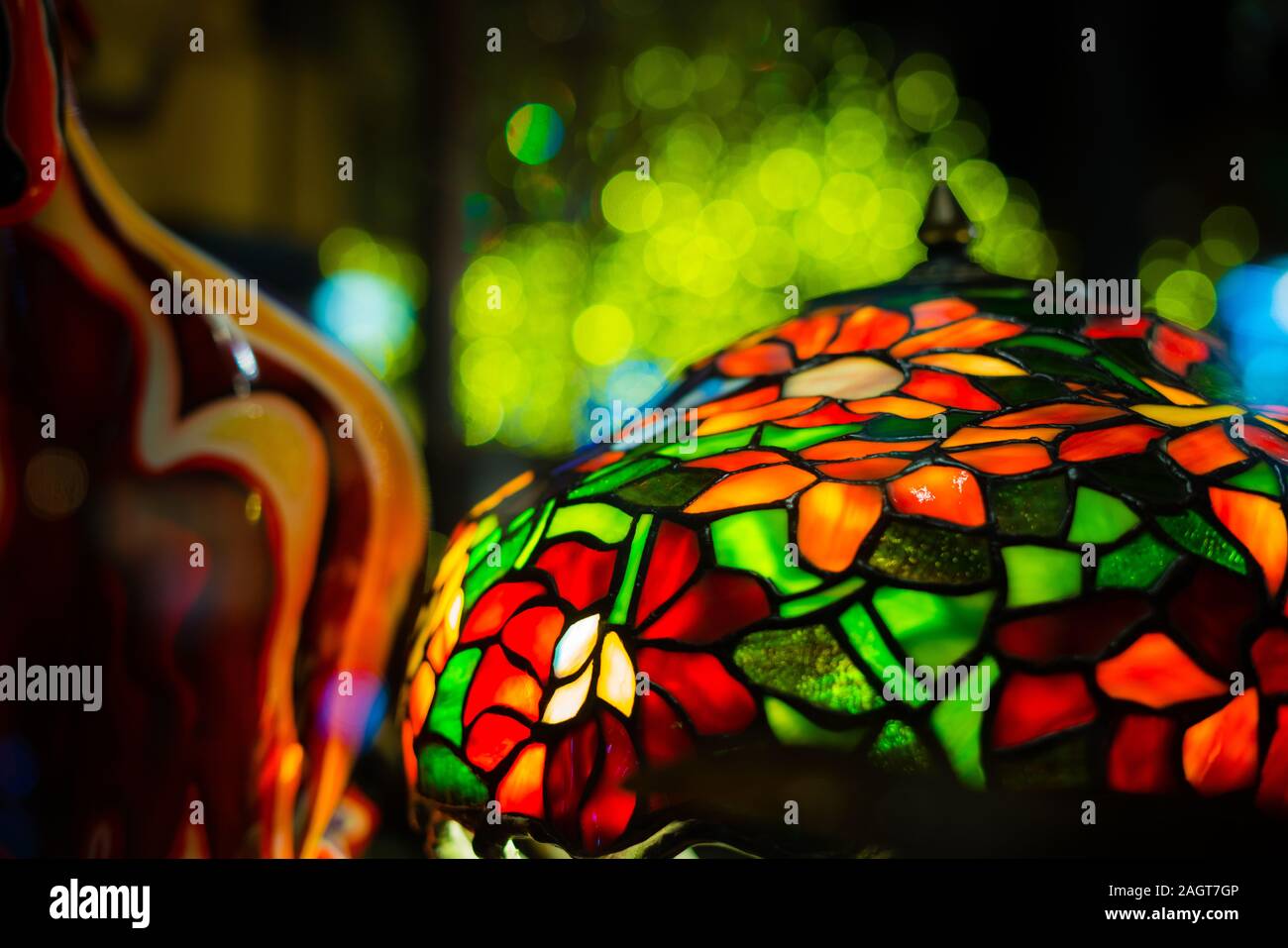 An antique tiffany lamp shade and bright colors on display in an abstract manner. Stock Photo
