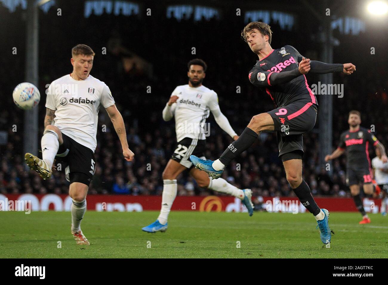 London, UK. 21st Dec, 2019. Patrick Bamford of Leeds United (R) takes a shot at goal which is deflected off Alfie Mawson of Fulham (L). EFL Skybet championship match, Fulham v Leeds Utd at Craven Cottage in London on Saturday 21st December 2019. this image may only be used for Editorial purposes. Editorial use only, license required for commercial use. No use in betting, games or a single club/league/player publications. pic by Steffan Bowen/Andrew Orchard sports photography/Alamy Live news Credit: Andrew Orchard sports photography/Alamy Live News Stock Photo