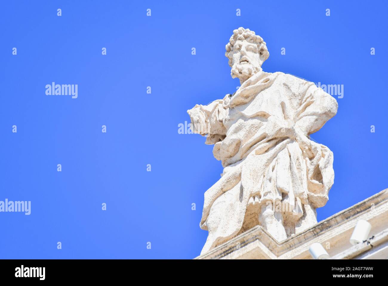 Ancient Saint Statue on Top of Bernini's Colonnade in Vatican City Stock Photo