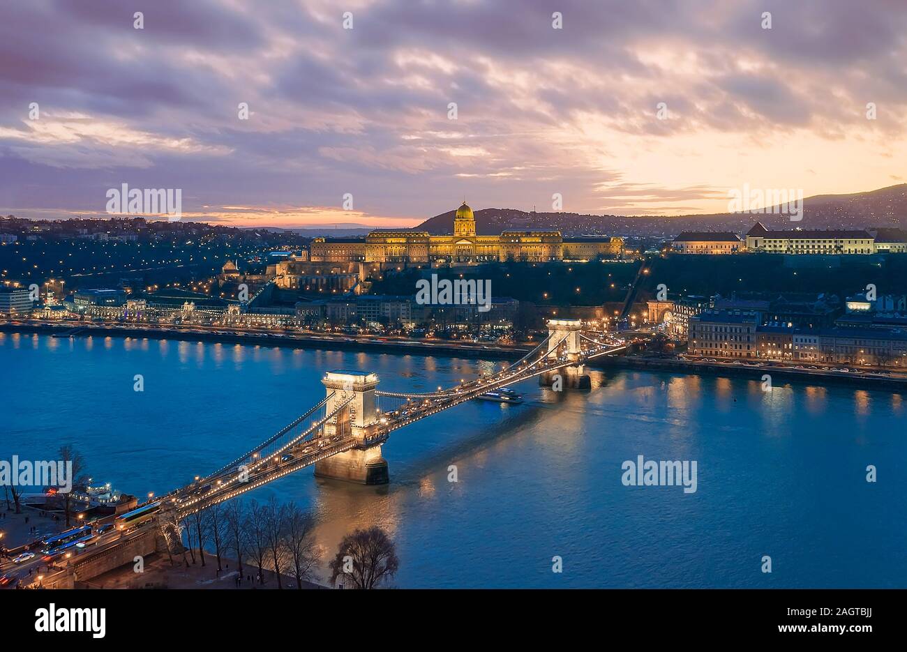 Sunset cityscape from Budapest with Danube river, Szechenyi chain bridge, Buda caslle, Varkert bazaar  and sandor palace. Stock Photo
