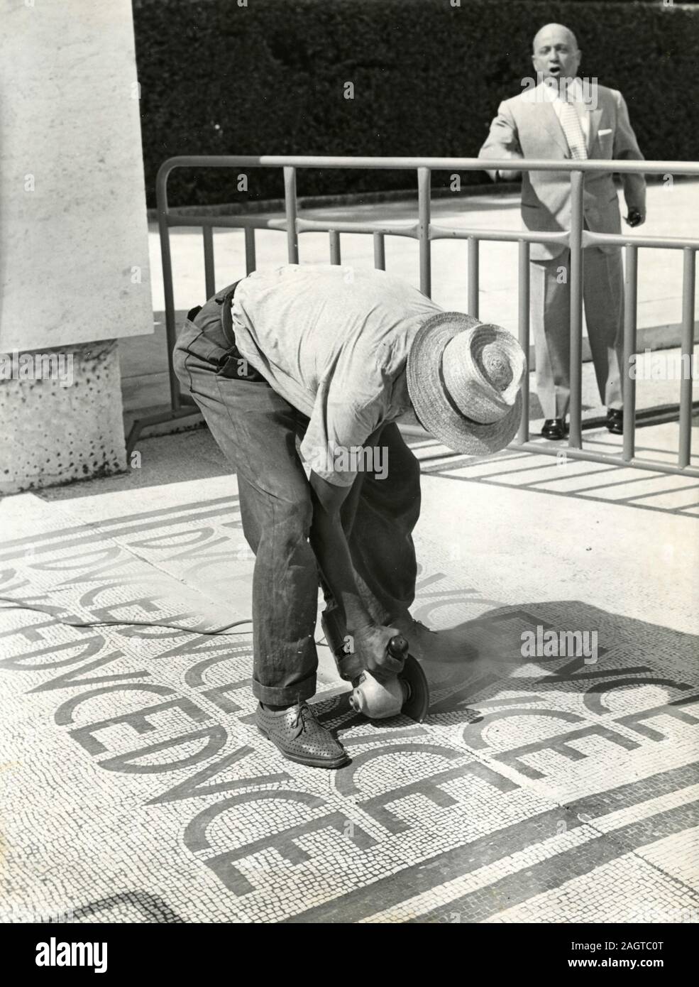 Italian politician senator Lando Ferretti looking at the works to delete the writings Duce at Foro Italiaco, Rome, Italy 1960 Stock Photo