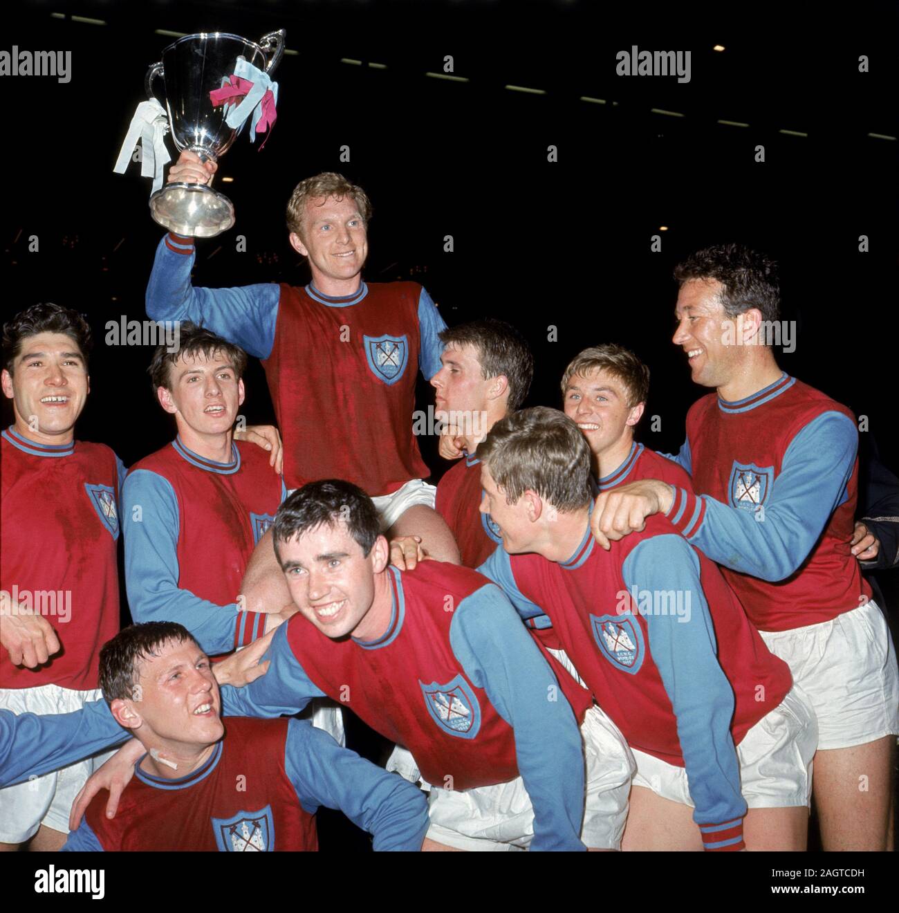 File photo dated 19-05-1965 of West Ham United celebrate with the European Cup Winners' Cup after their 2-0 win: (back row, l-r) Alan Sealey, Martin Peters, Bobby Moore (with cup), Geoff Hurst, John Sissons and Ken Brown. (Front row, l-r) Brian Dear, Ronnie Boyce and Jack Burkett. Stock Photo